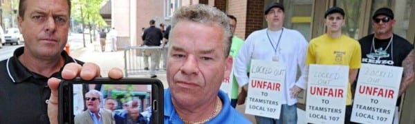 Shawn Dougherty, secretary-treasurer and business agent for Teamsters Local 107, shows his cellphone video of John Dougherty (no relation), of IBEW Local 98, crossing a Teamsters picket line. Photo credit: Clem Murray, Philly Inquirer